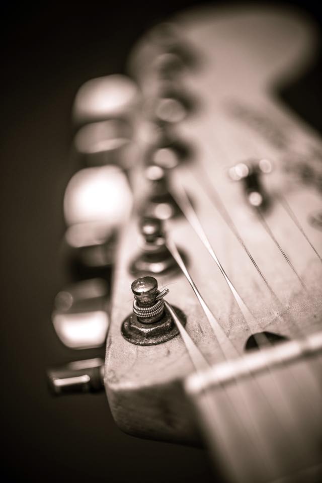 Headstock of a fender stratocaster in black and white.